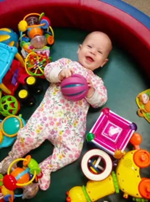 116 Infant Playing With Toys 2 Web